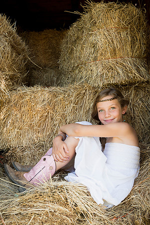 Portrait of a girl sitting in straw
